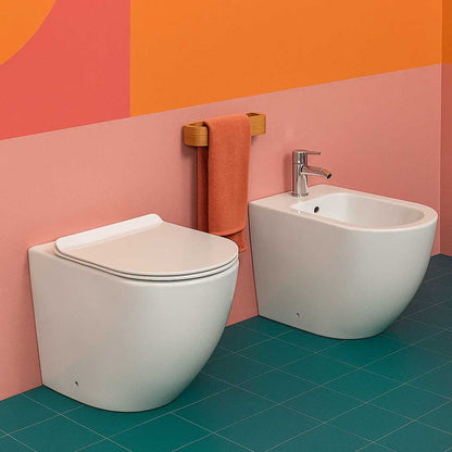 Floor-mounted wall-hugging Bathcore sanitary set with included toilet seat cover - Aura series